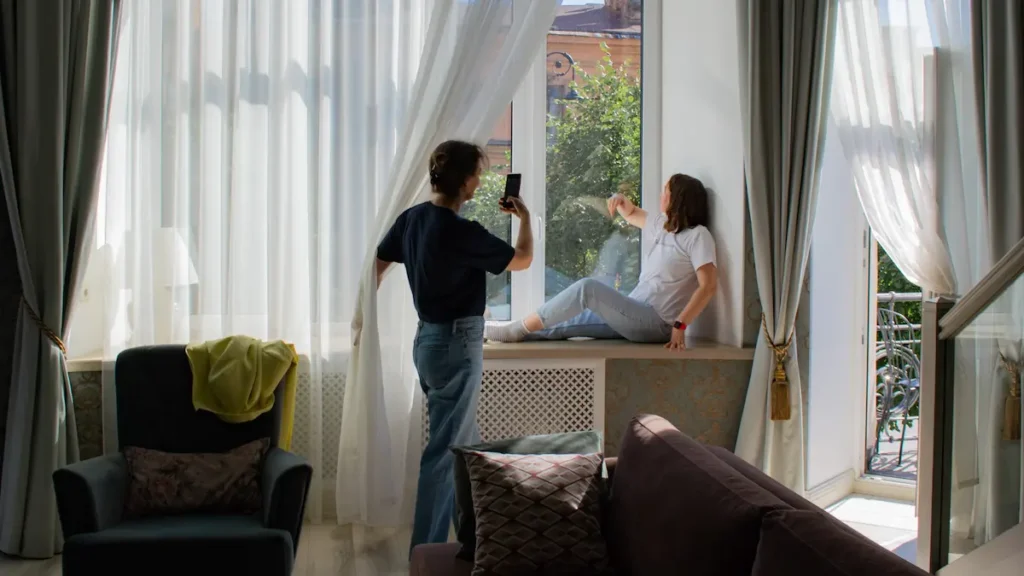 girls on window of hotel